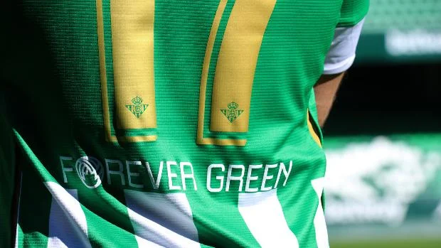 Real Betis players embracing in Forever Green shirts